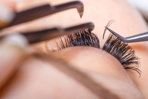 Applying eyelash extensions meticulously